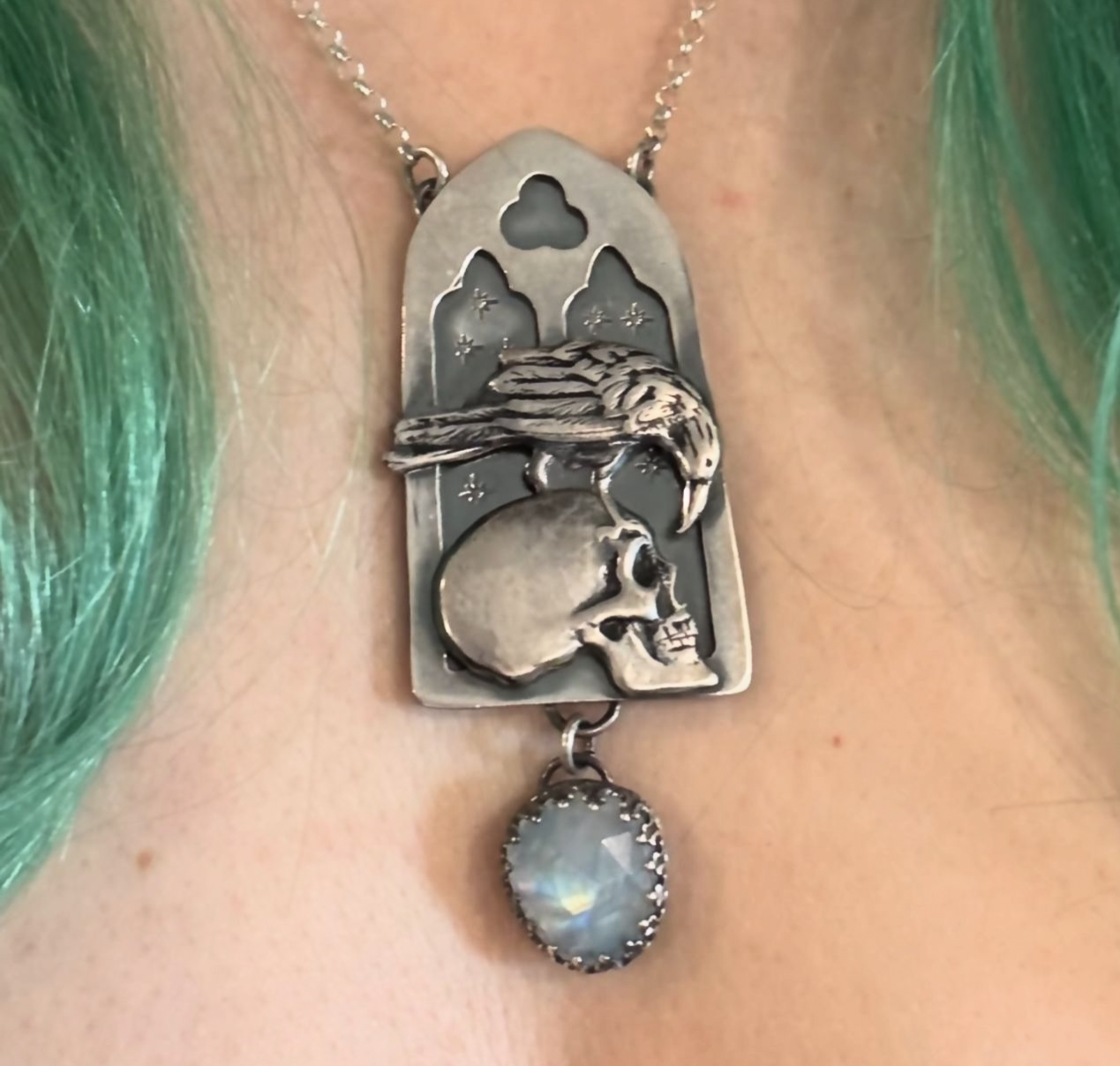 Haven Noir~Made to order~Hand crafted sterling and fine silver cathedral window with raven perched on human skull with a rose cut rainbow moonstone droplet necklace ~