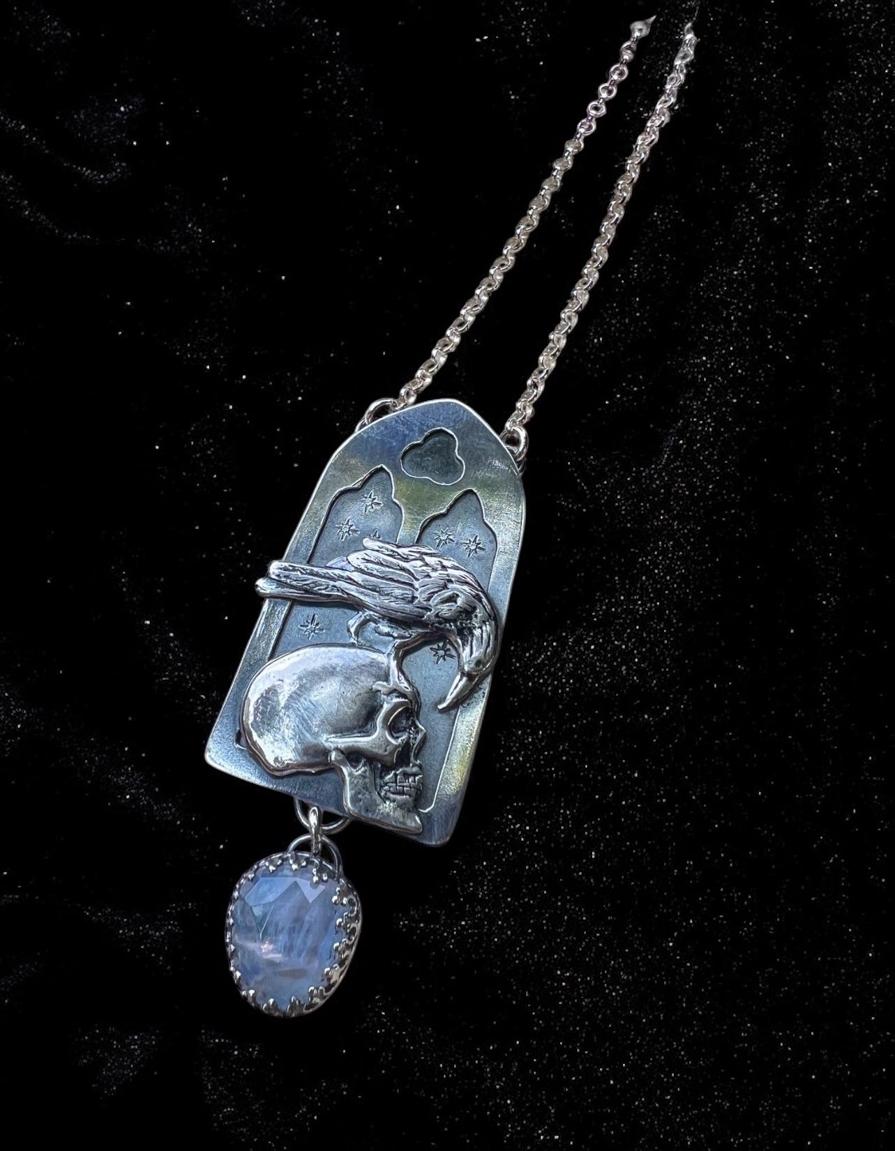 Haven Noir~Made to order~Hand crafted sterling and fine silver cathedral window with raven perched on human skull with a rose cut rainbow moonstone droplet necklace ~